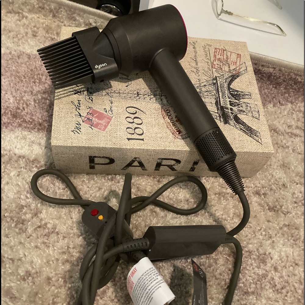 Dyson hair dryer with attachments. Used once. Purchased from Saks. No box